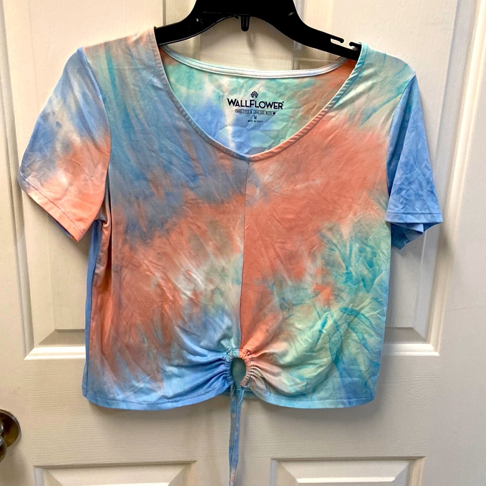 Tie dye shirt with tie at bottom.